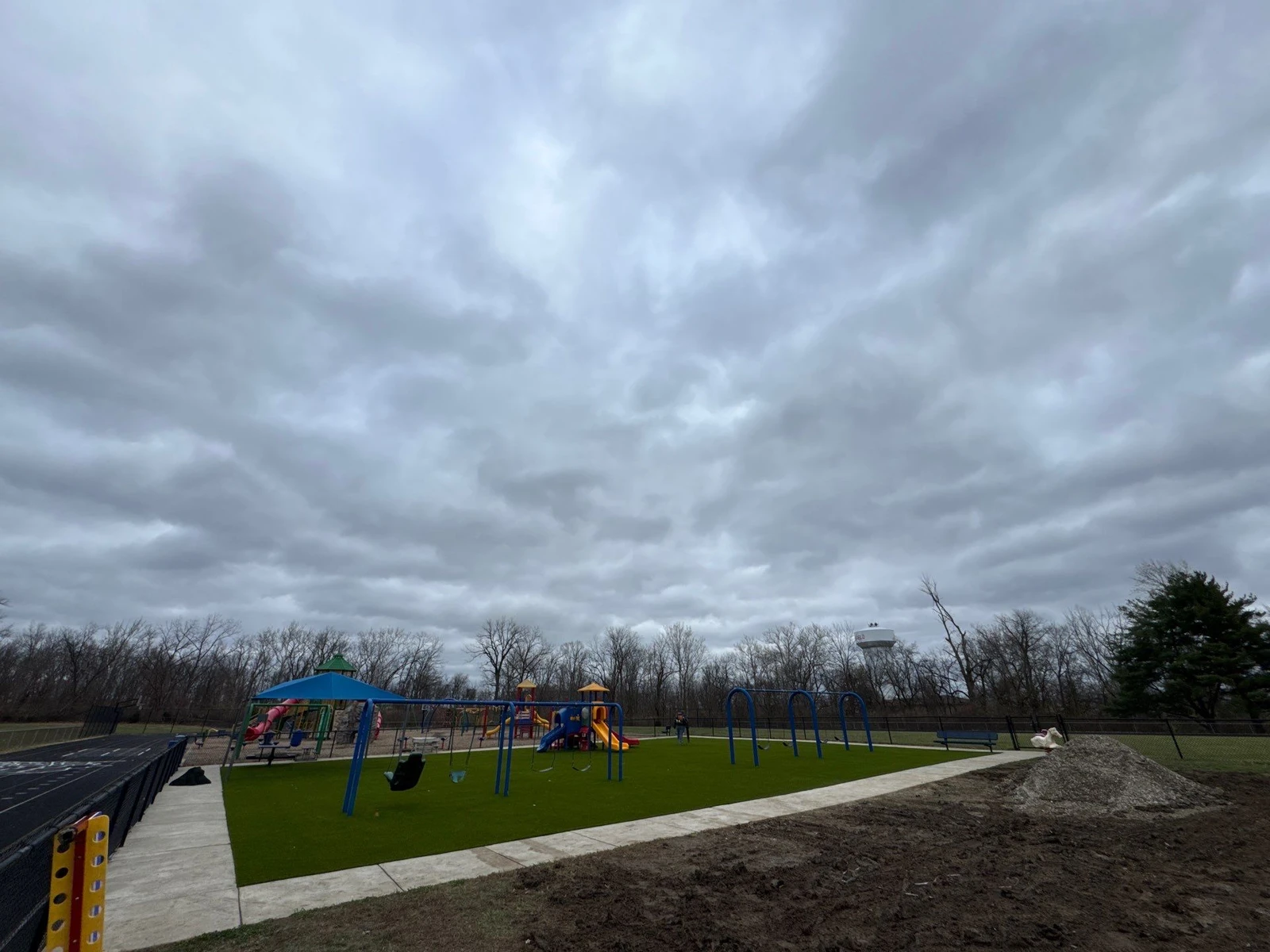 ForeverLawn Playground Grass installation at Clarks Creek Municipal Park in Plainfield with swing sets and colorful play structures