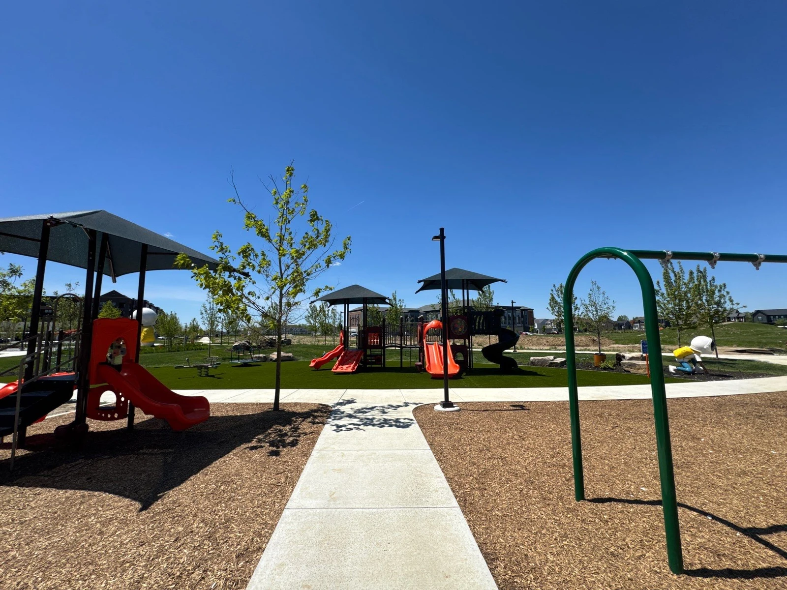 ForeverLawn Playground Grass installed around colorful play structures with slides at Hobbs Park, Plainfield IN